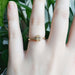 Champagne diamond engagement ring in yellow gold, worn on a hand
