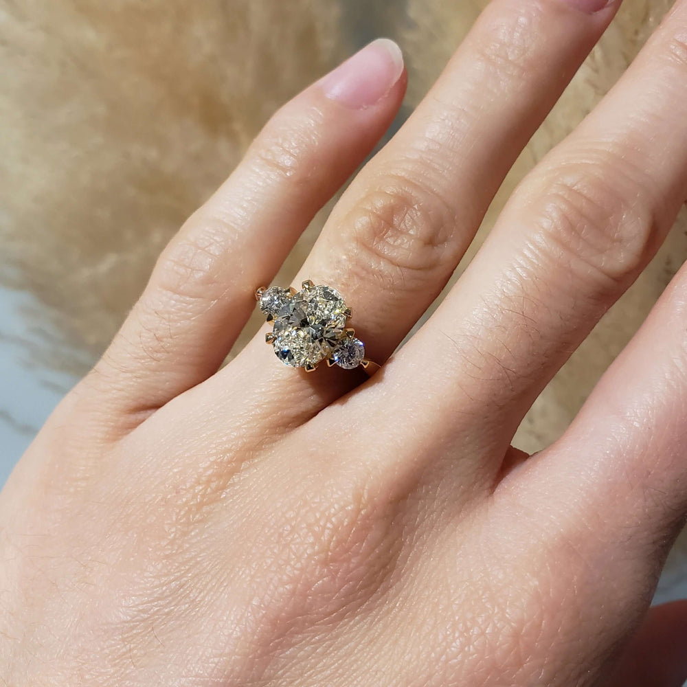 14kt yellow gold three-stone lab diamond ring worn on hand