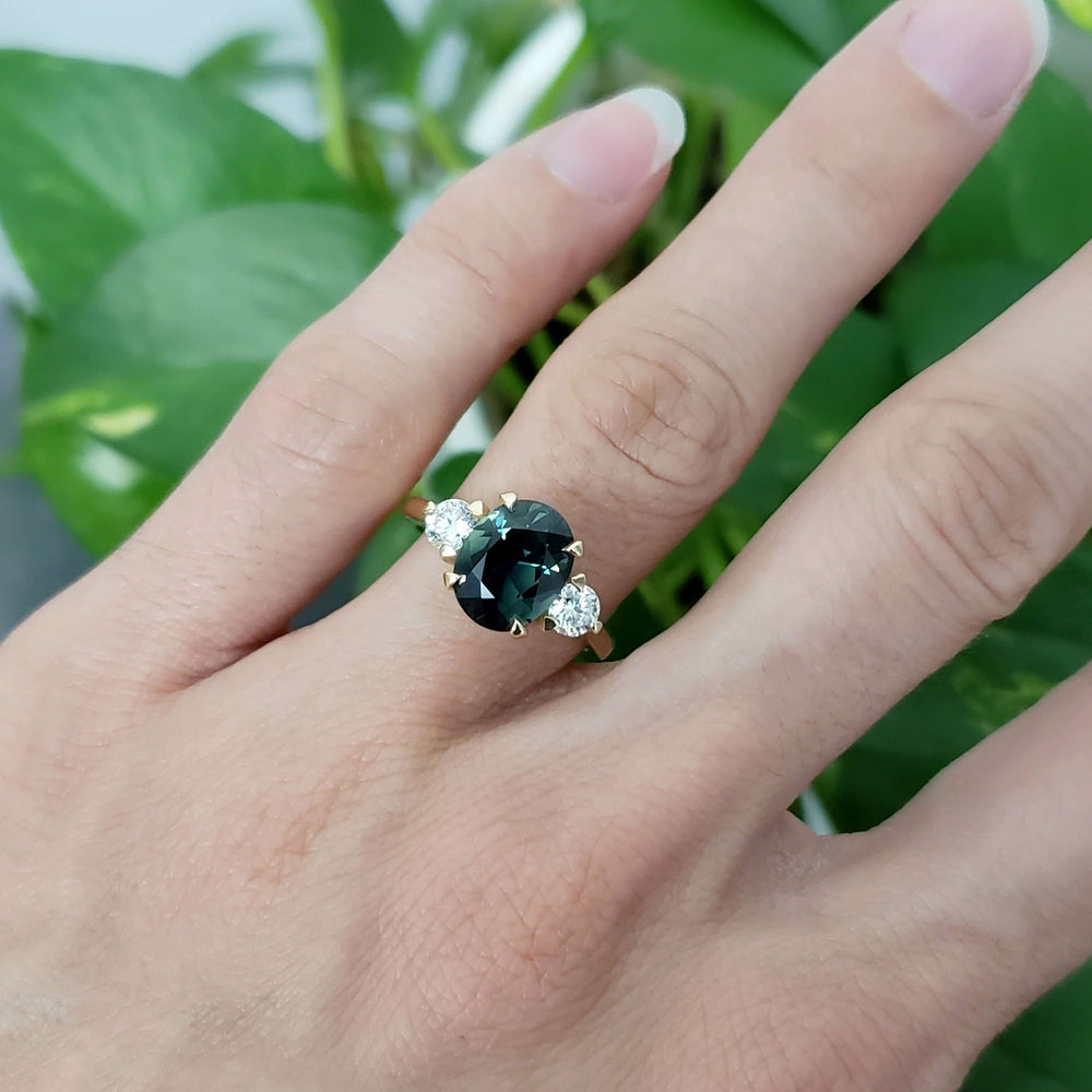 Charlotte Australian sapphire and lab diamond ring worn on a hand