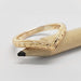 Chevron-shaped yellow gold wedding ring with hand-engraved wheat pattern, resting on a pencil