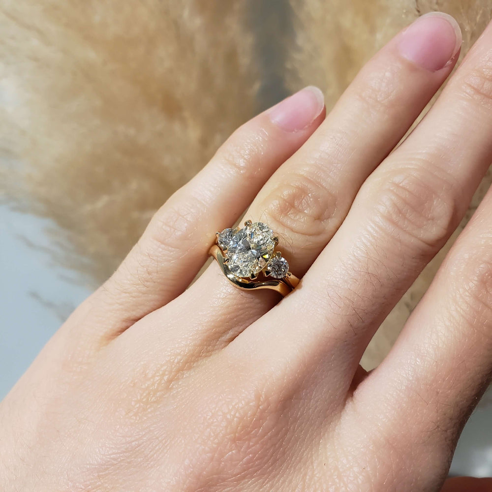 Chevron 14kt yellow gold wedding band stacked with diamond engagement ring