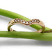 Chevron diamond band in 14kt rose gold displayed on green stems