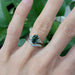 Chevron diamond wedding band stacked with green sapphire and diamond engagement ring