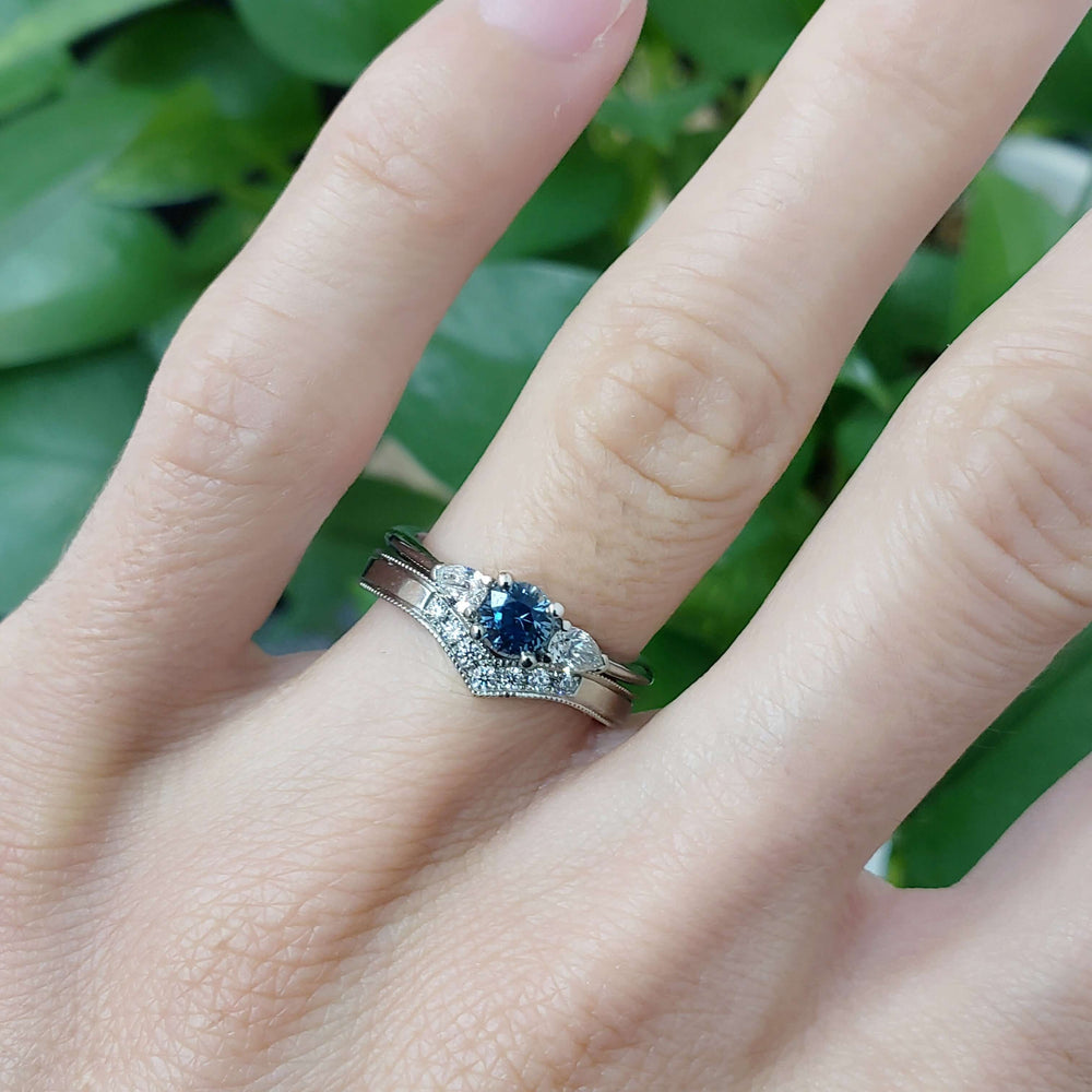 Chevron diamond wedding band stacked with blue sapphire and diamond engagement ring