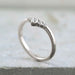 Chevron diamond wedding ring in 14kt white gold on stone background