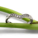 Chevron diamond wedding ring in 14kt white gold displayed on green stems