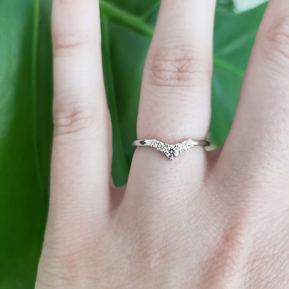 14kt white gold chevron diamond wedding ring shown on hand