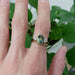 Chevron diamond wedding ring stacked with green sapphire and diamond engagement ring