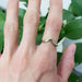 Chevron millgrain yellow gold ring worn on hand