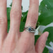 Chevron pavé diamond wedding ring stacked with sapphire and diamond rings on hand