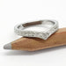 Chevron wedding ring in 14kt white gold with engraved floral and wheat pattern, shown on pencil