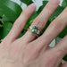 Chevron wedding ring in yellow gold stacked with green sapphire and diamond ring