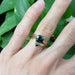 Chevron yellow gold wedding ring paired with teal sapphire engagement ring