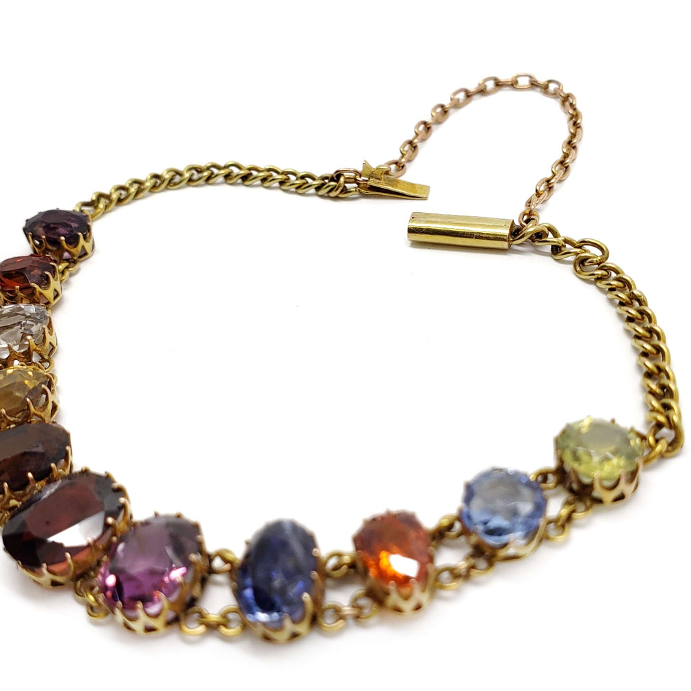 Close-up of the clasp and gemstones on a 14kt yellow gold antique harlequin bracelet