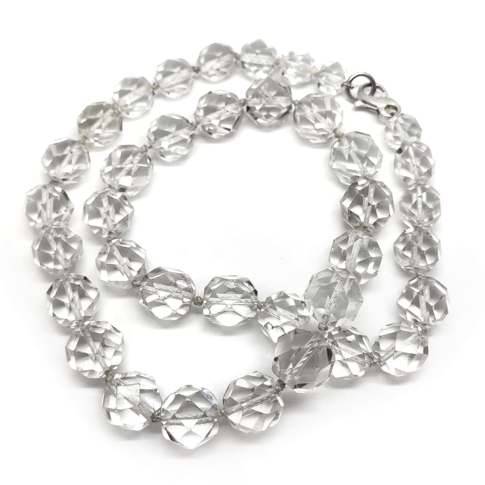 Faceted clear quartz bead necklace with sterling silver clasp on white background