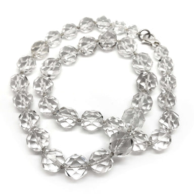 Faceted clear quartz bead necklace with sterling silver clasp on white background