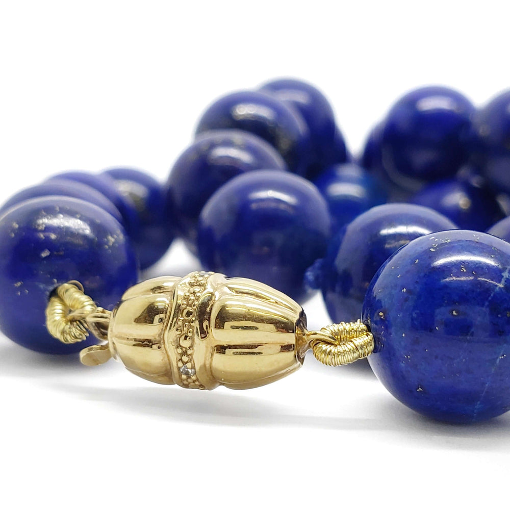 Close-up of 14kt yellow gold and diamond clasp on lapis lazuli bead necklace