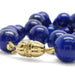 Close-up of 14kt yellow gold and diamond clasp on lapis lazuli bead necklace