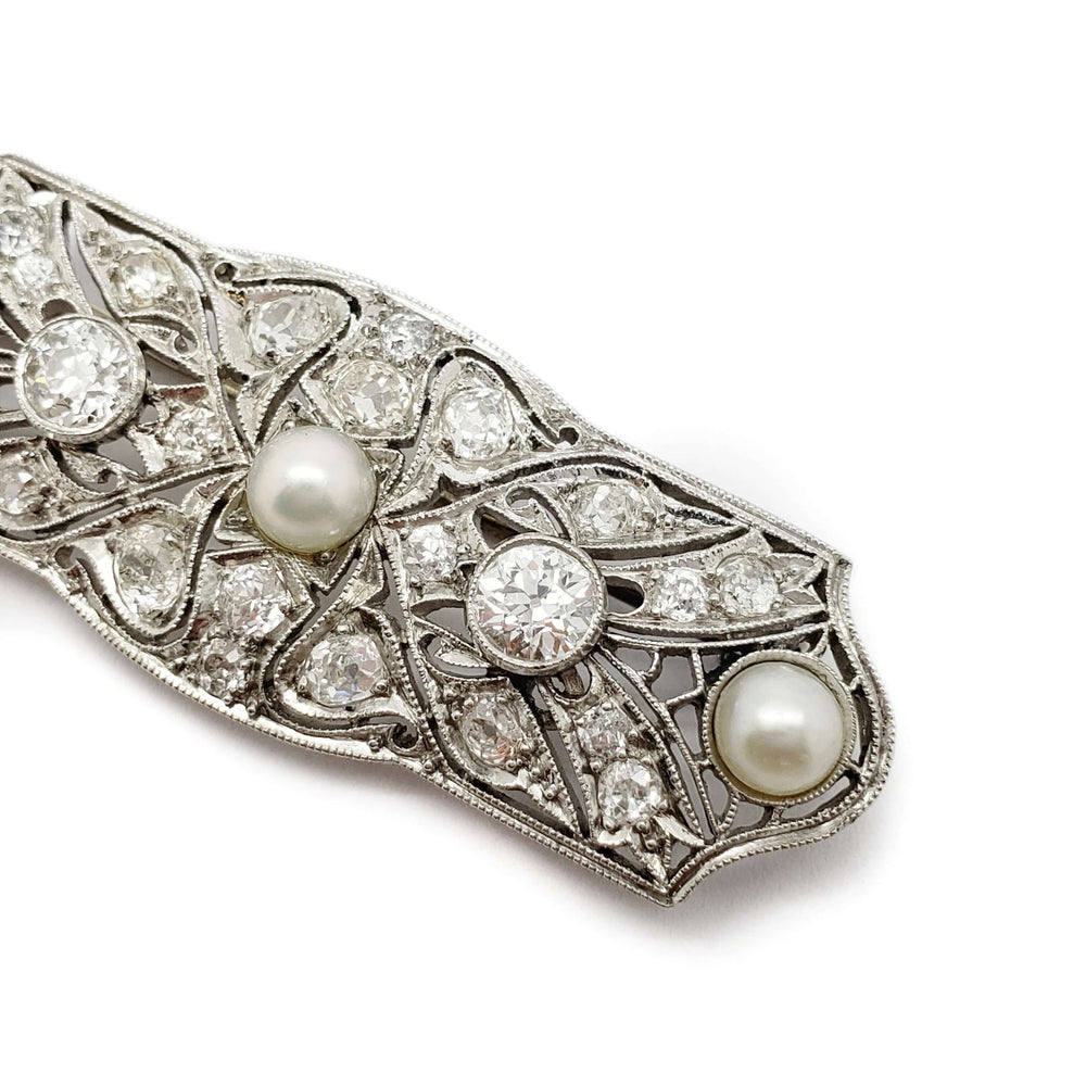 Close-up of platinum Edwardian brooch with old cut diamonds and pearls in intricate setting