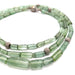 Close-up of elongated green tourmaline beads and textured white gold beads on necklace