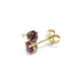 Close-up of 14k yellow gold lab-grown alexandrite stud earrings with butterfly backs