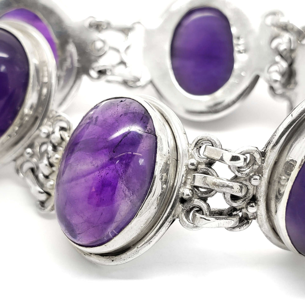 Close-up of oval cabochon amethyst set in sterling silver bracelet