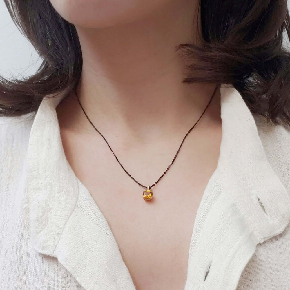 Cushion citrine pendant necklace in yellow gold worn on model