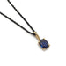 Cushion cut deep blue sapphire pendant in 14kt yellow gold on a black chain, front view
