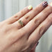 Cushion cut lab diamond engagement ring in yellow gold shown on hand