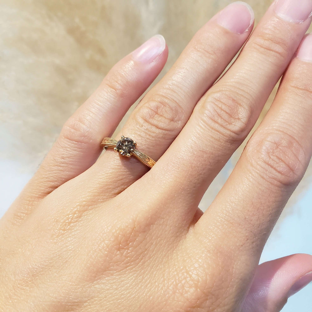 Champagne diamond engagement ring in 14kt yellow gold shown on hand