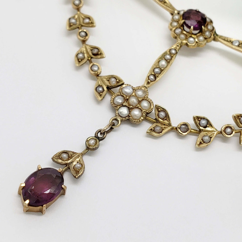Close-up of antique necklace with seed pearls and oval amethyst in 14kt yellow gold
