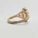 Detailed engraving on 14kt yellow gold band of marquise lab diamond engagement ring