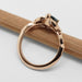 Detailed side view of 14k rose gold sapphire and diamond leaf engagement ring