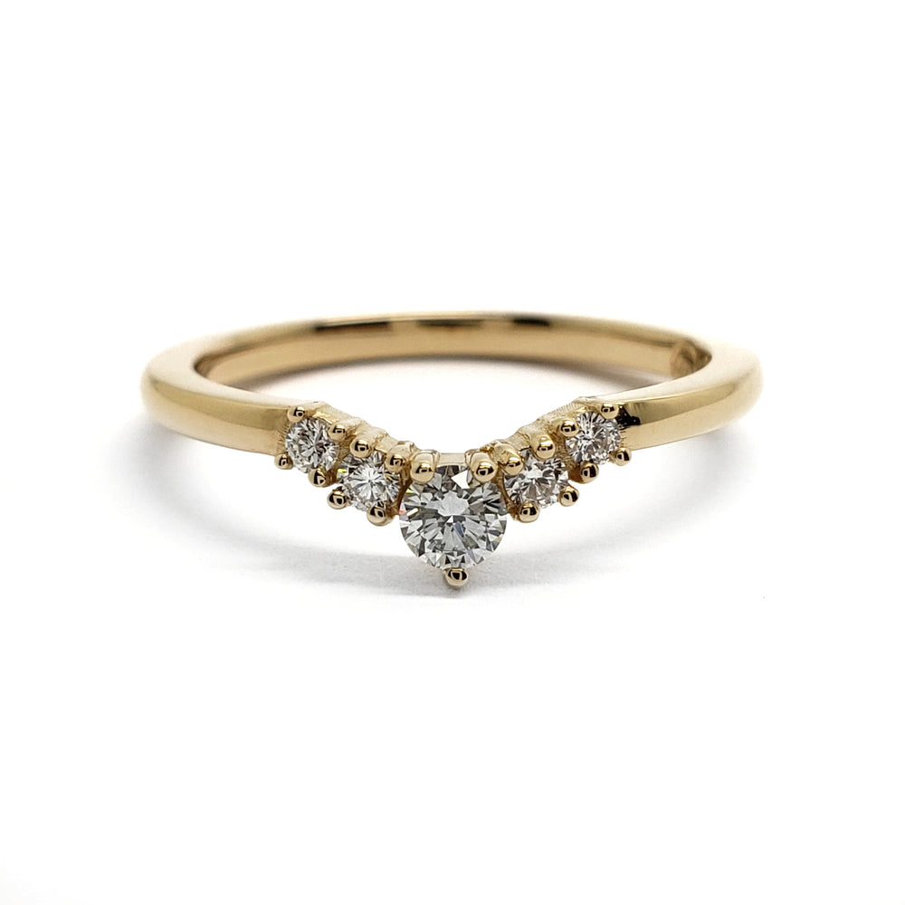 A yellow gold V-shaped ring featuring a central round diamond flanked by smaller round diamonds, set against a plain white background.