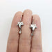 14kt white gold leaf dangle earrings with bezel set diamonds shown on fingers