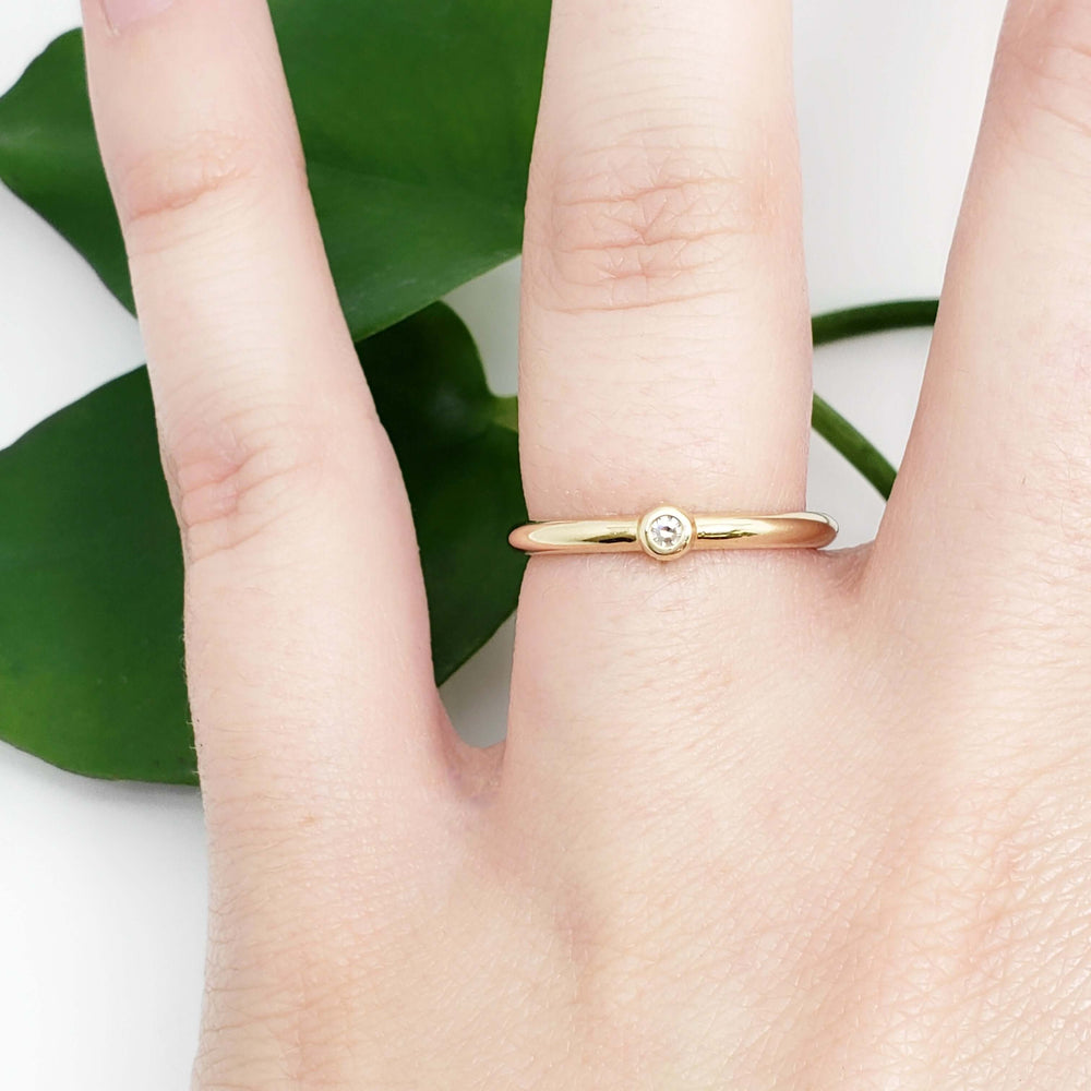 Diamond stacker yellow gold ring worn on a hand