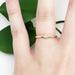 Diamond stacker yellow gold ring worn on a hand