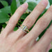 Yellow gold diamond wedding band stacked with a three-stone baguette gemstone ring