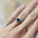 Diamond wedding ring stacked with a sapphire engagement ring on hand