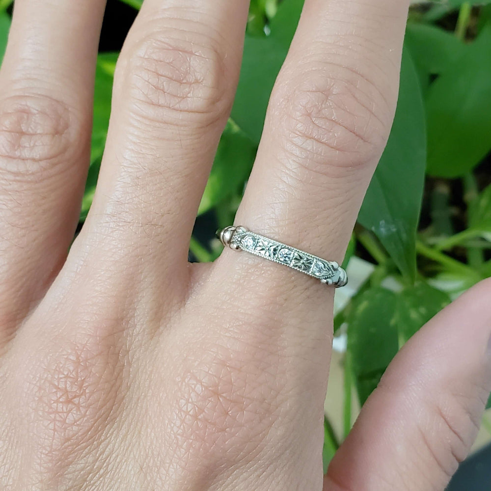 Diana Luxe white gold diamond wedding ring with millgrain, shown on a hand