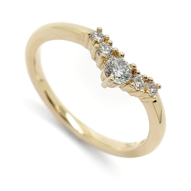 A yellow gold five-stone diamond ring with a marquise-cut center stone and three round-cut accent stones, shown on a clean white background.
