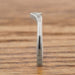 Edge view of 14k white gold chevron wedding band with millgrain detail