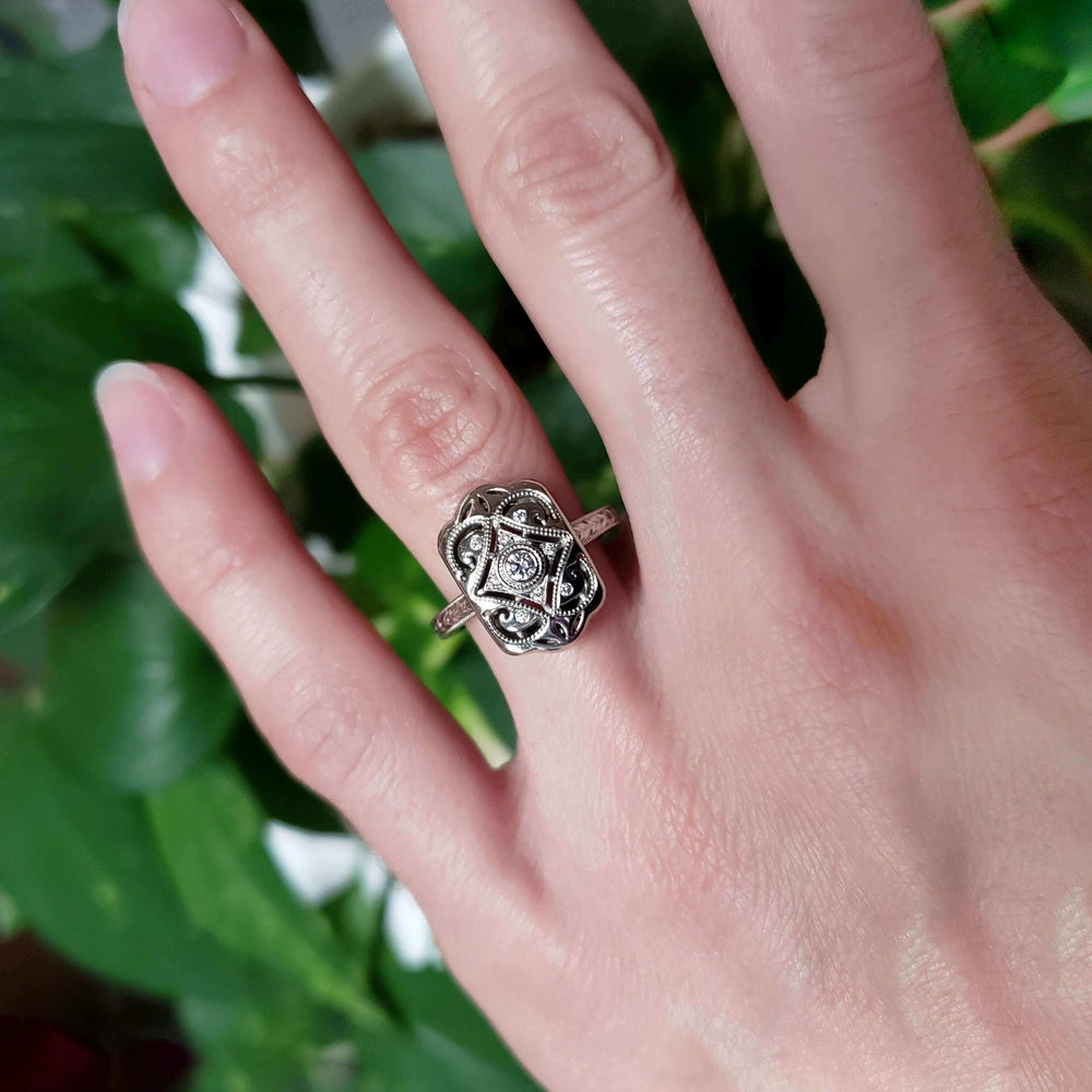 Edwardian diamond engagement ring in white gold shown on hand