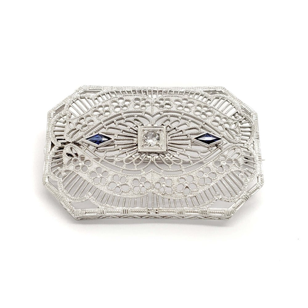 Edwardian filigree brooch in white gold with glass centre and two blue synthetic sapphires