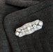 Edwardian platinum diamond and pearl brooch styled on a dark wool jacket lapel