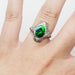 Edwardian platinum opal and diamond ring shown on hand, top view