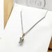 Emerald cut aquamarine pendant in 10kt yellow gold on a silver chain, displayed in Era Design box