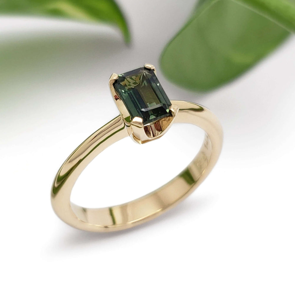 Emerald cut green Tanzanian sapphire engagement ring in 14kt yellow gold, with leaves