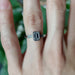 Emerald cut lab diamond engagement ring in white gold, worn on hand