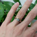 Engraved 14k yellow gold chevron wedding ring stacked with solitaire engagement ring
